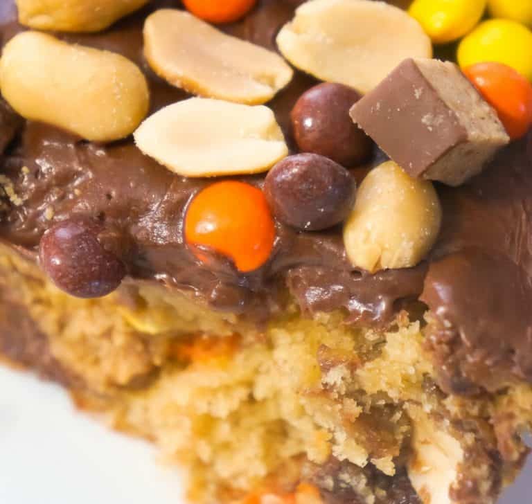 Ultimate Peanut Butter Banana Sheet cake is an easy chocolate peanut butter dessert recipe using boxed cake mix. This delicious cake is topped with chocolate frosting and loaded with peanut butter cups, Reese's Pieces and peanuts.