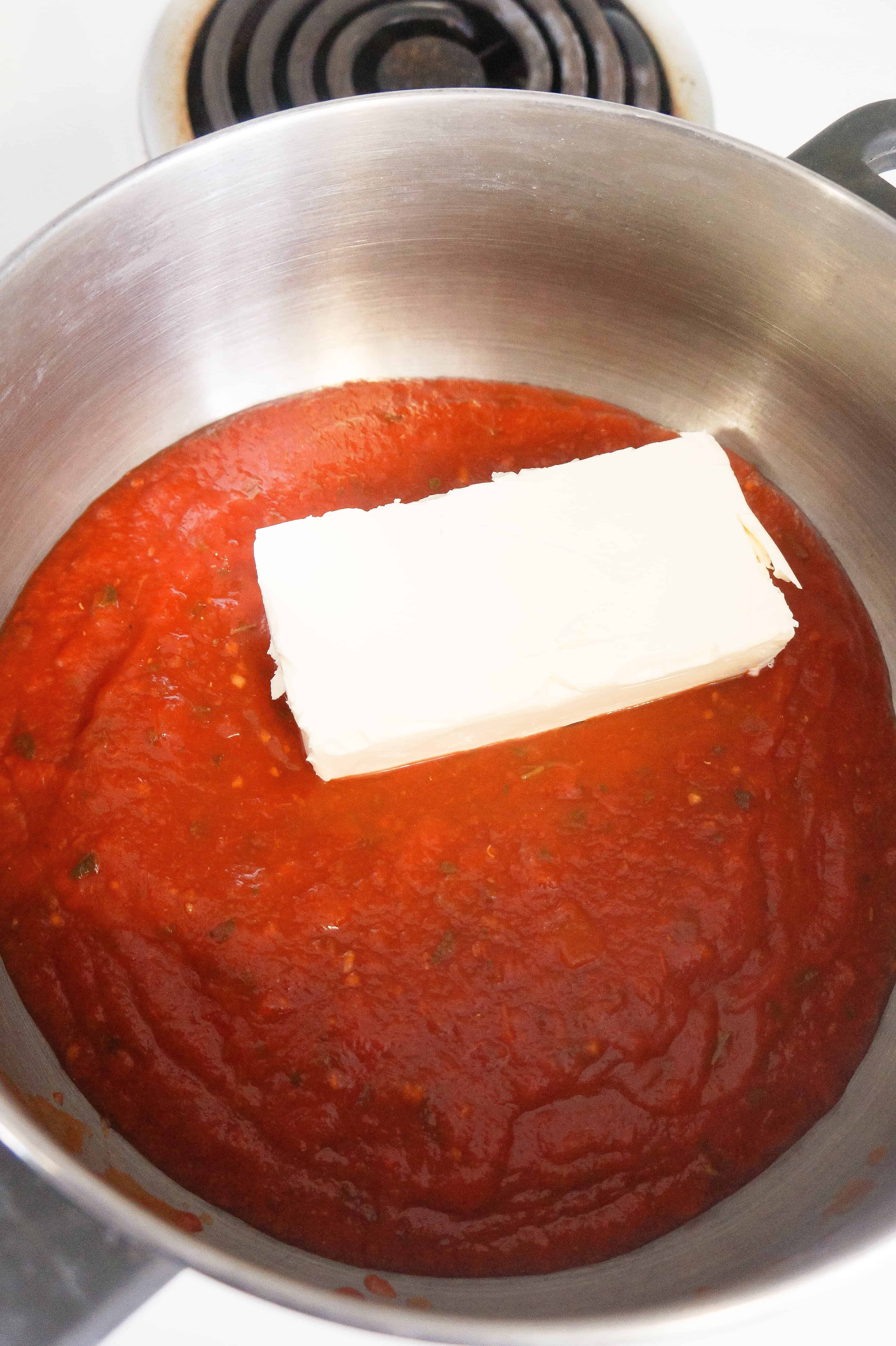 marinara sauce with a brick of cream cheese