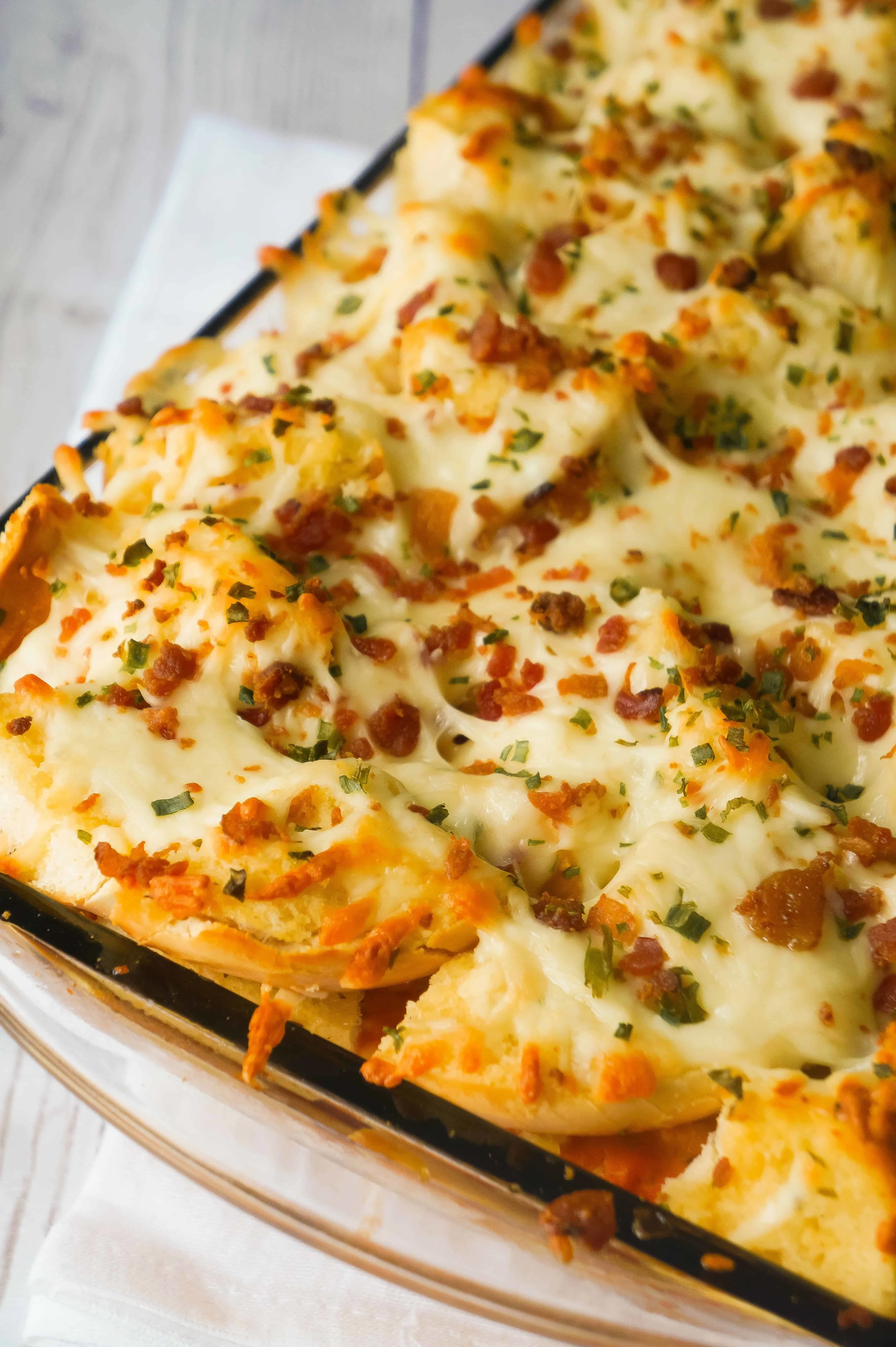 baked spaghetti and meatball casserole topped with garlic cheese bread