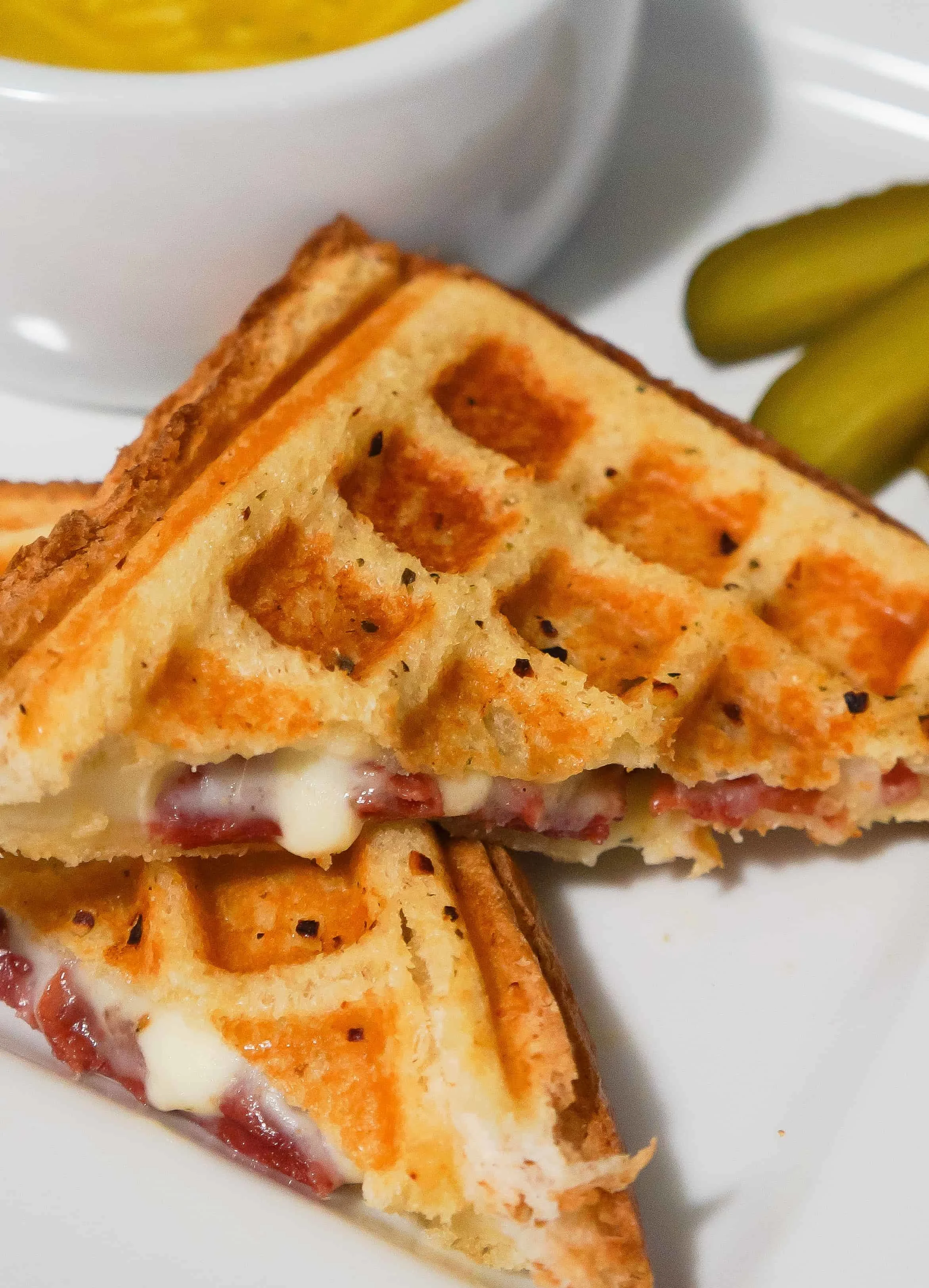 Grilled cheese sandwich with sauteed onions, corned beef and Havarti cheese cooked in a waffle maker. This waffled grilled cheese is perfect for lunch or a quick dinner.